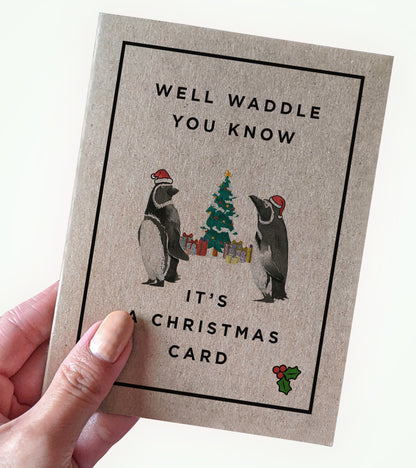 Well Waddle You Know penguin Christmas card held in hand